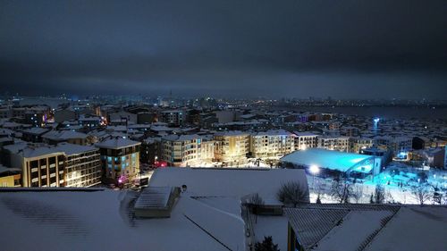 High angle view of illuminated cityscape against sky at night