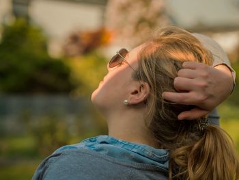 Portrait of young woman wearing sunglasses outdoors