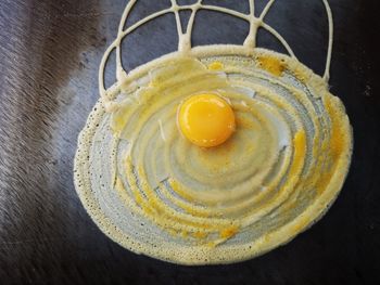 High angle view of yellow eggs in container on table