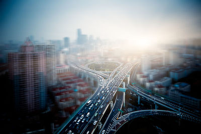 Aerial view of buildings in city against sky