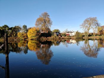 Reflection of trees in lake against sky