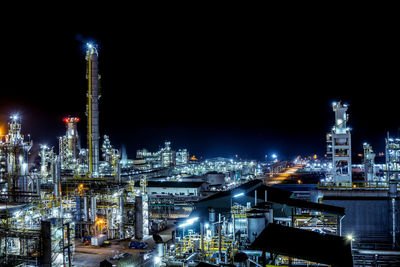 High angle view of illuminated buildings against sky at night