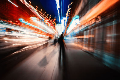 Blurred motion of people in city at night