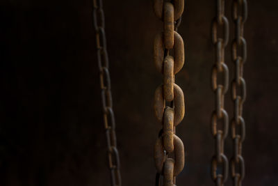 Close-up of chains against wall