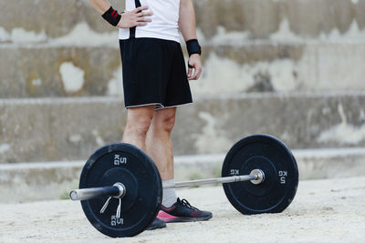 Weightlifter standing before lifting weights in an urban environment.