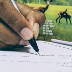 Close-up of hand holding book