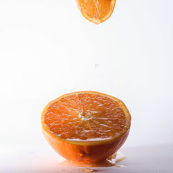 Close-up of orange slice against white background