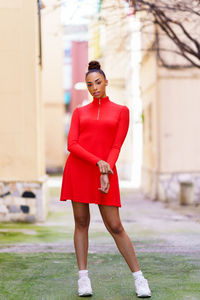 Portrait of young woman standing in city