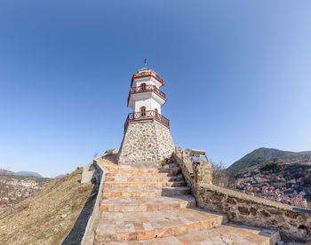 Low angle view of building against clear blue sky