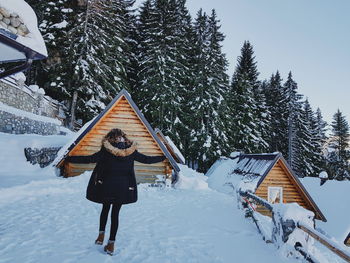 Low angle view of person on snowcapped mountain against sky