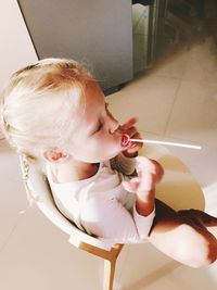High angle view of woman holding girl at home