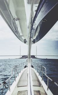 Close-up of ship sailing on sea against sky