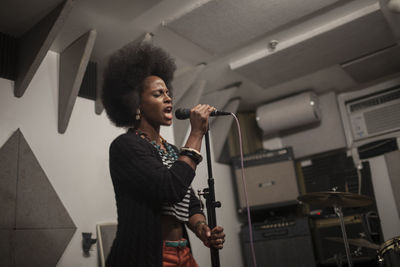 Singer performing in a recording studio