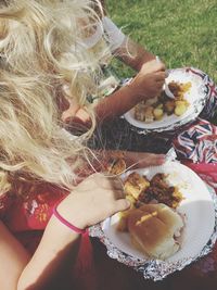 High angle view of woman holding ice cream in plate