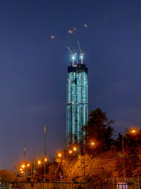 Illuminated cityscape against sky at night