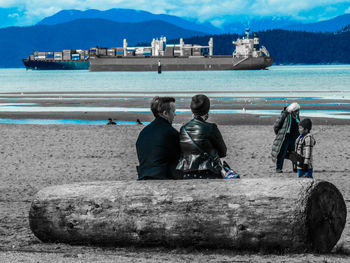 Rear view of people looking at sea