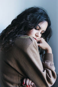 Close-up of woman standing against wall