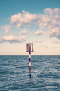 Lifeguard hut in sea against sky