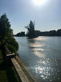 Scenic view of river against sky on sunny day