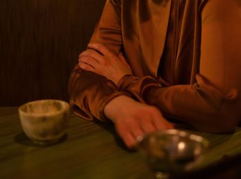 Midsection of man sitting on table