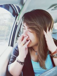 Young woman while traveling in car