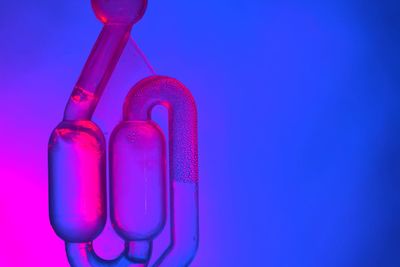 Close-up of glass bottle against blue background