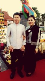 Portrait of young couple standing outdoors