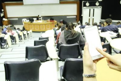 Rear view of people sitting on chair