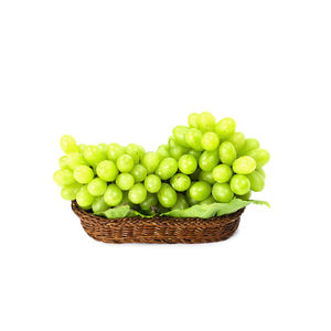 Close-up of fruits in bowl against white background