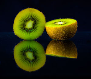 Close-up of fruits on table against black background