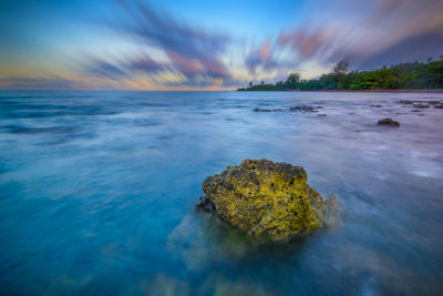 Scenic view of sea against sky at sunset