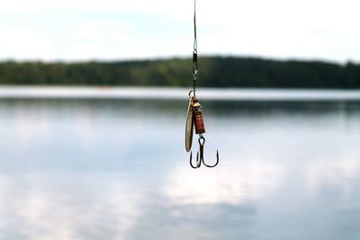 Fishing rod on rope against lake