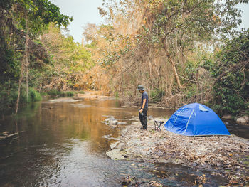 People enjoying in lake at forest