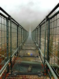 Bridge over footbridge against sky