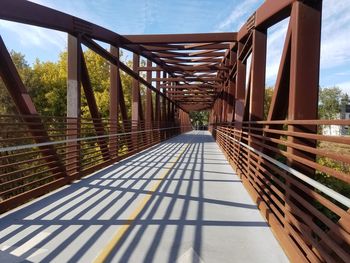 Empty footbridge against sky