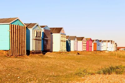 Houses on beach against clear sky