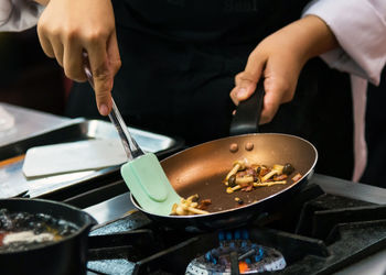 Midsection of man preparing food