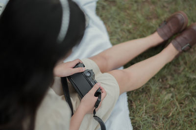 Midsection of man holding camera