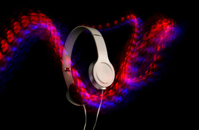 Digital composite image of light painting against black background