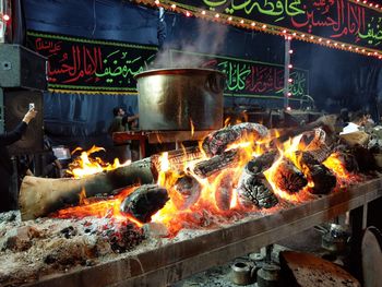 Burning candles on barbecue grill