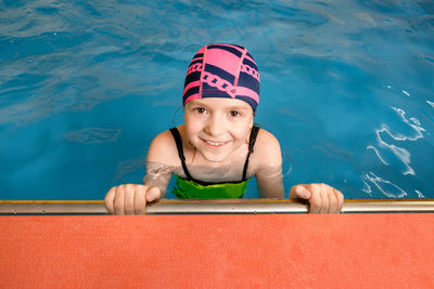 High angle portrait of smiling girl in swimming pool