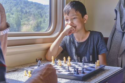 Boy sitting on window sill