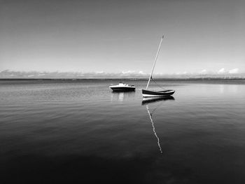 Boat moored on sea against sky