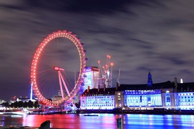 Low angle view of illuminated ferris wheel at night