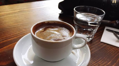 Close-up of cappuccino served on table