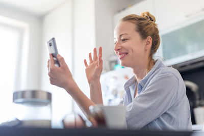 Midsection of woman using smart phone