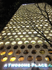 Low angle view of illuminated lighting equipment on building