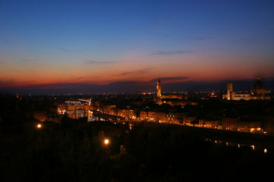 High angle view of illuminated buildings against sky at night