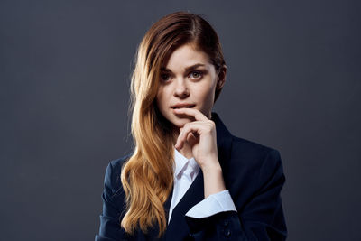 Portrait of beautiful young woman over black background