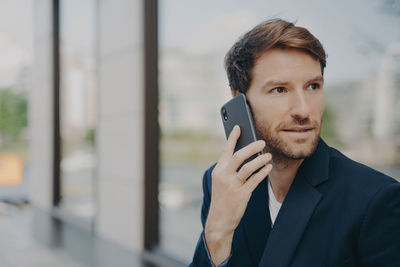 Portrait of young man using mobile phone